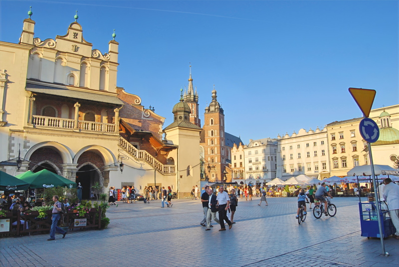 23 - The historic Main Market Square in Kraków, Poland, featuring the Renaissance Cloth Hall (Sukiennice) on the left and the Gothic spires of St. Mary's Basilica in the background